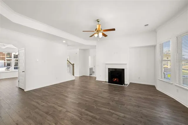 a view of a livingroom with a ceiling fan and window