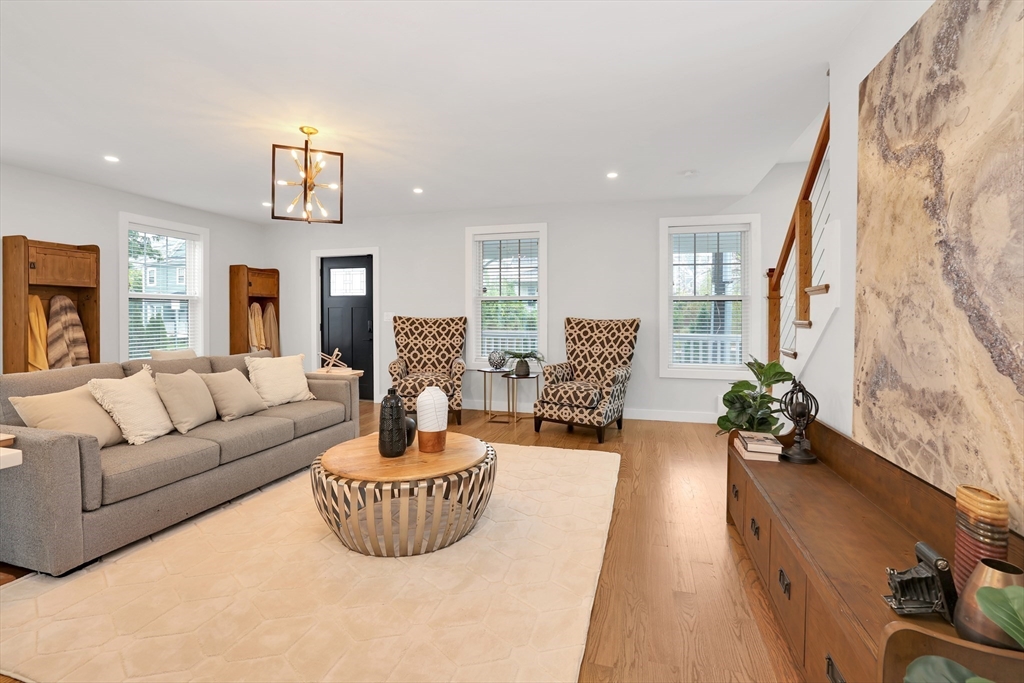 34 Temple Street Boston, MA 02126 - Photo 11 of 38 a living room with fireplace furniture and a chandelier