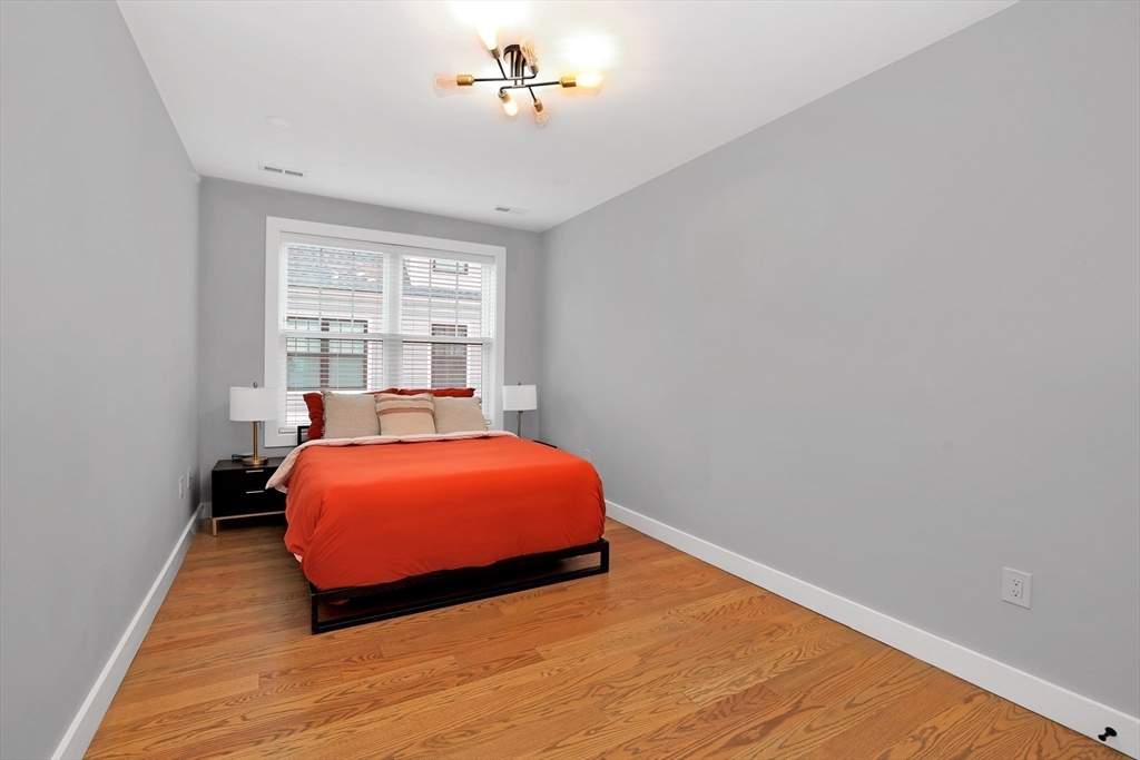 34 Temple Street Boston, MA 02126 - Photo 15 of 38 a bedroom with a bed and window