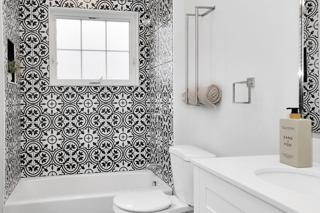 34 Temple Street Boston, MA 02126 - Photo 21 of 38 a bathroom with a sink a toilet and a tub
