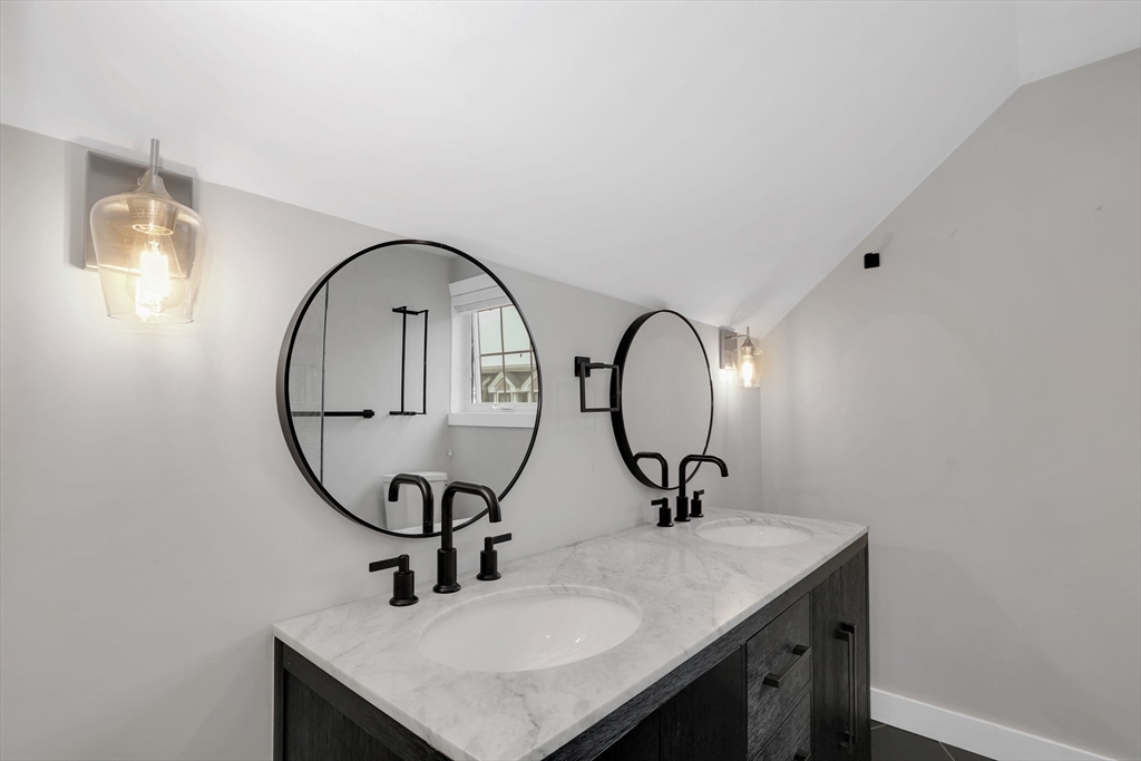 34 Temple Street Boston, MA 02126 - Photo 26 of 38 a bathroom with a sink and a mirror