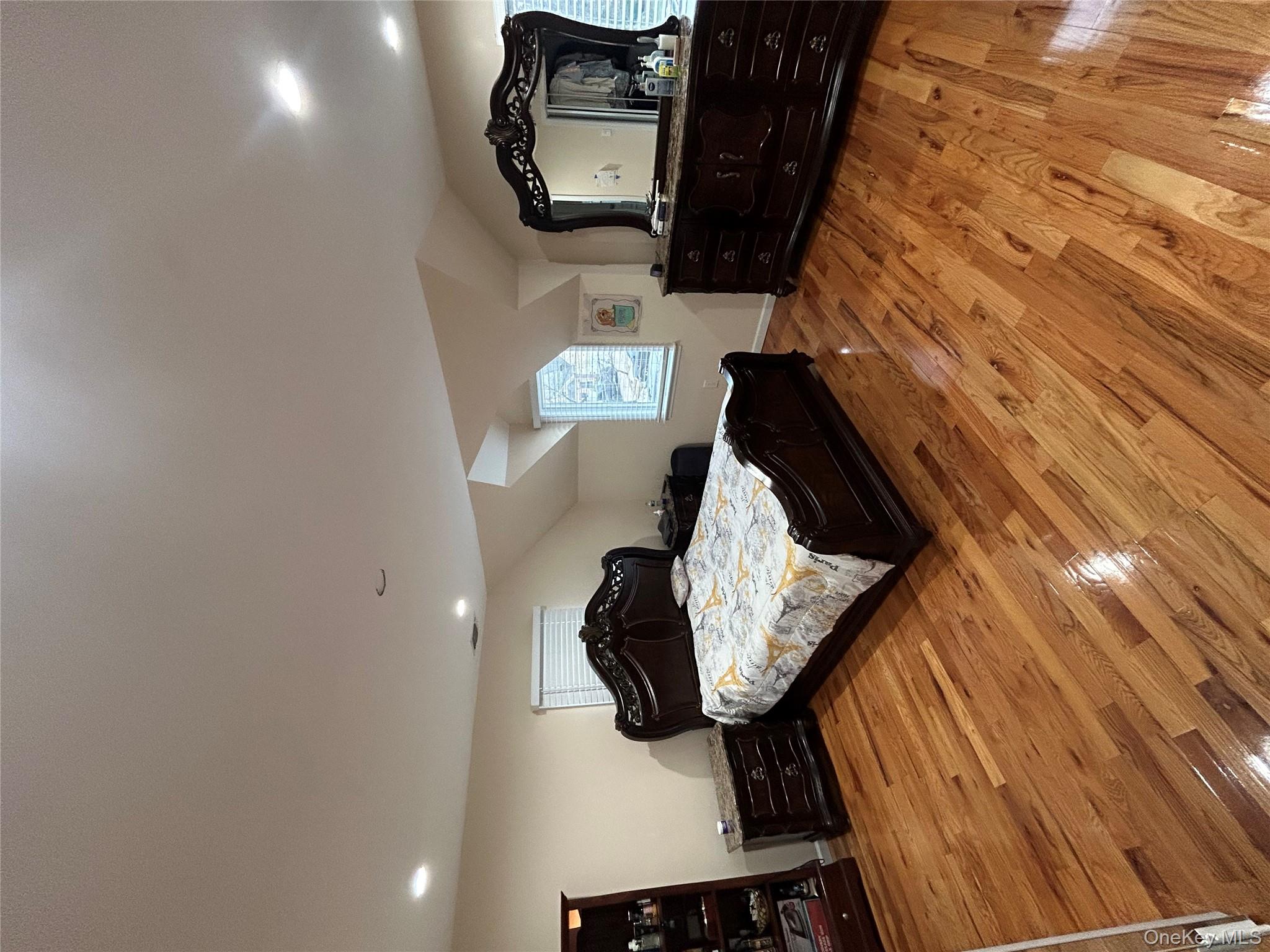 869 Demott Avenue Baldwin, NY 11510 - Photo 11 of 15 a bedroom with a bed and a view in kitchen