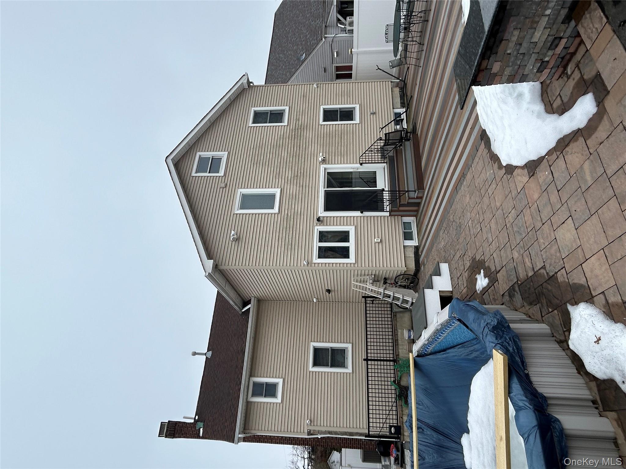 869 Demott Avenue Baldwin, NY 11510 - Photo 2 of 15 a backyard of a house with yard fire pit and outdoor seating