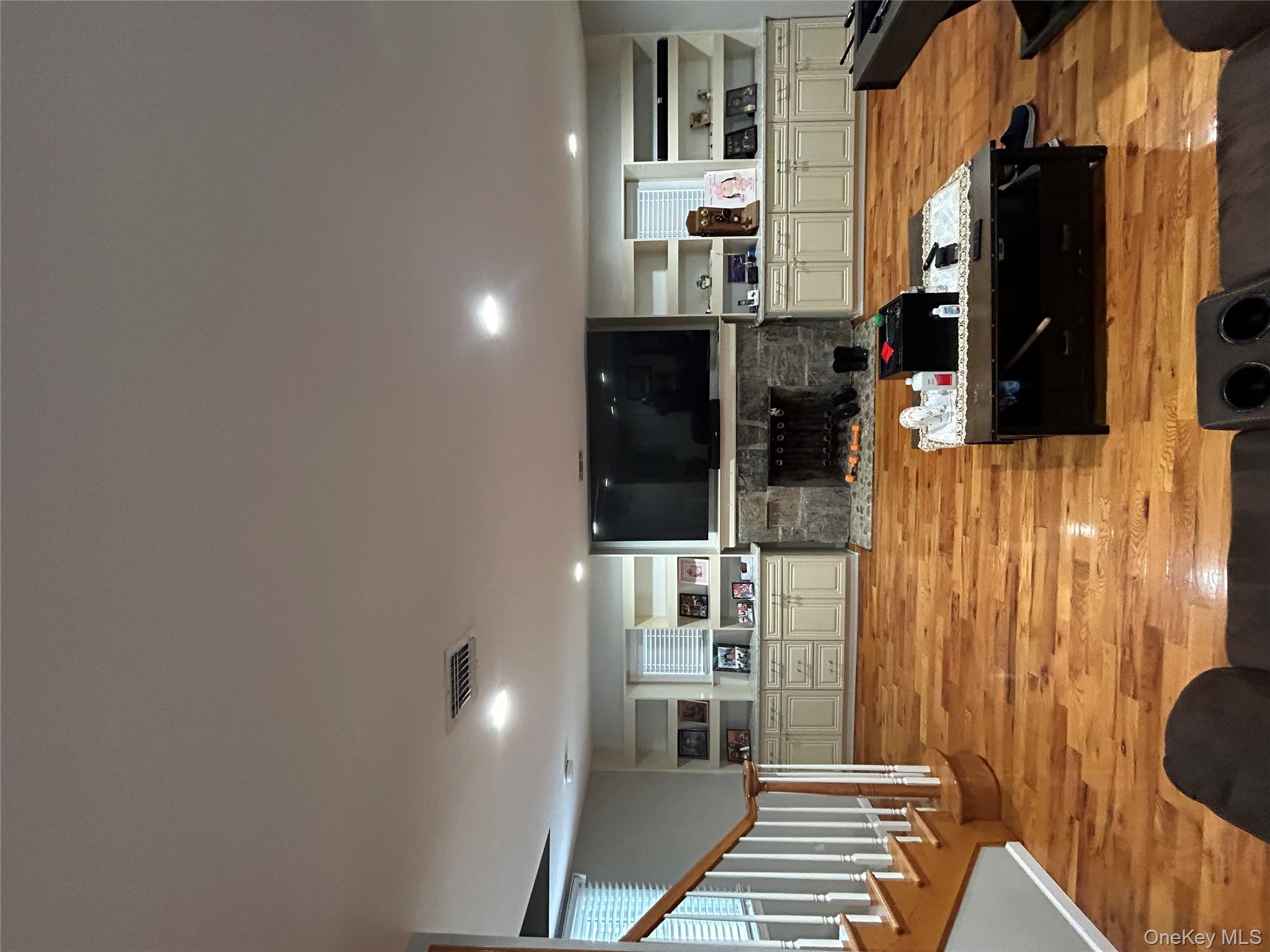 869 Demott Avenue Baldwin, NY 11510 - Photo 5 of 15 a living room with furniture and a flat screen tv