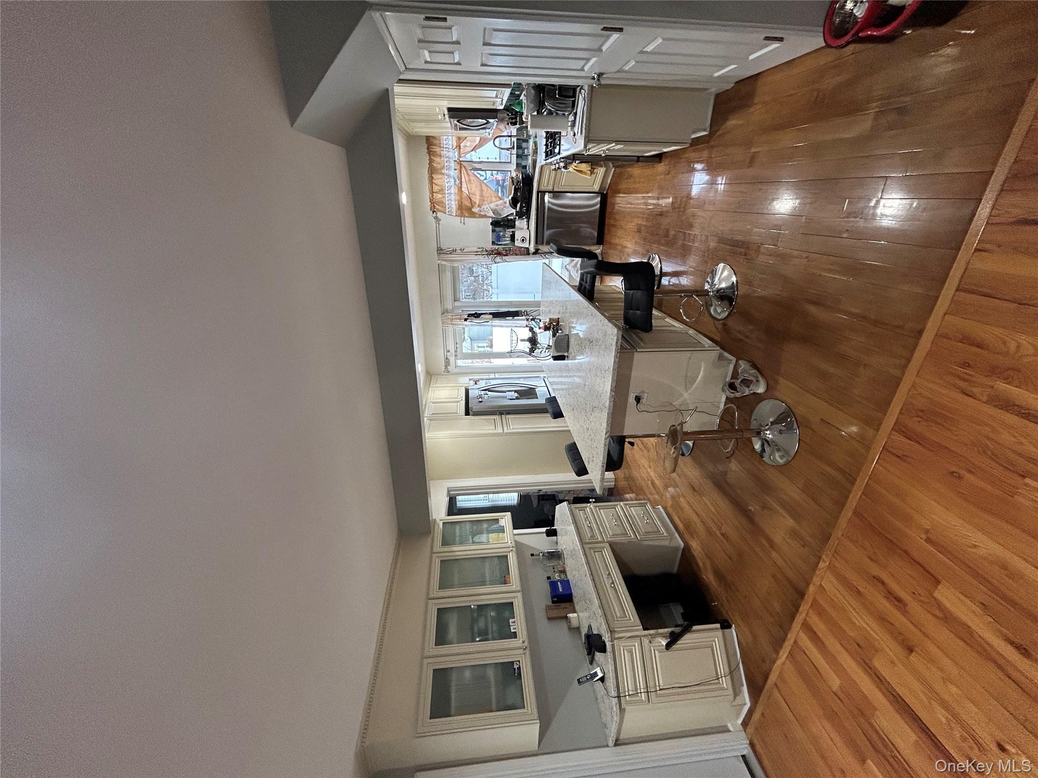 869 Demott Avenue Baldwin, NY 11510 - Photo 6 of 15 a living room with furniture and a wooden floor