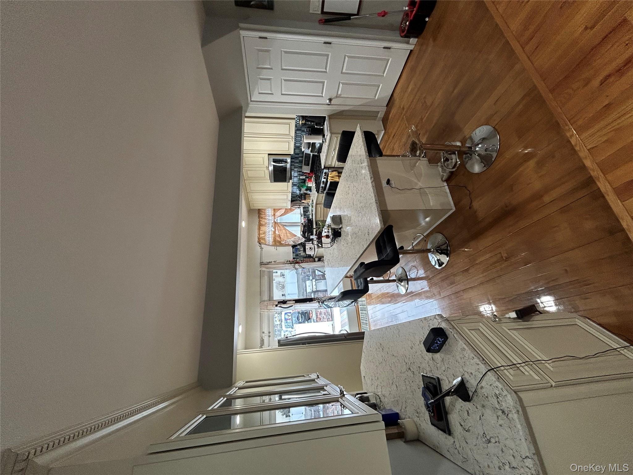 869 Demott Avenue Baldwin, NY 11510 - Photo 7 of 15 a living room with furniture a rug and white walls