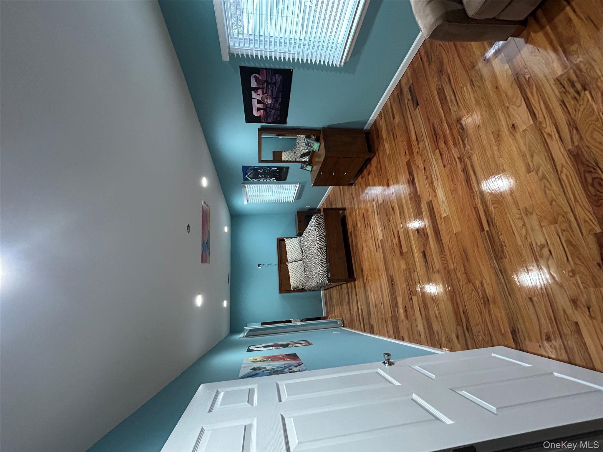 869 Demott Avenue Baldwin, NY 11510 - Photo 10 of 15 a bed room with furniture and a window