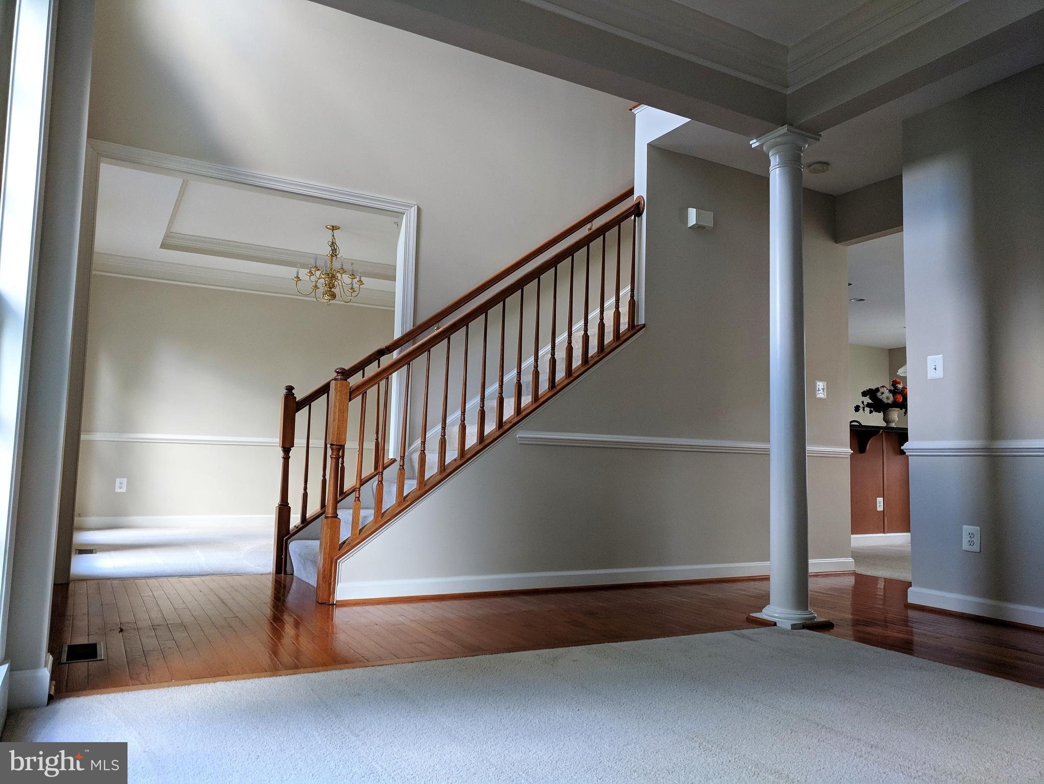 Two story foyer with hardwood.