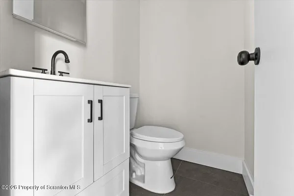 a bathroom with a sink toilet and a mirror