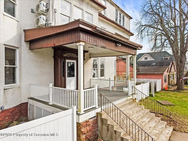 a view of a house with wooden fence
