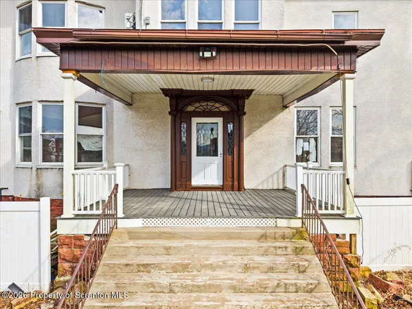 a view of a brick house with large windows