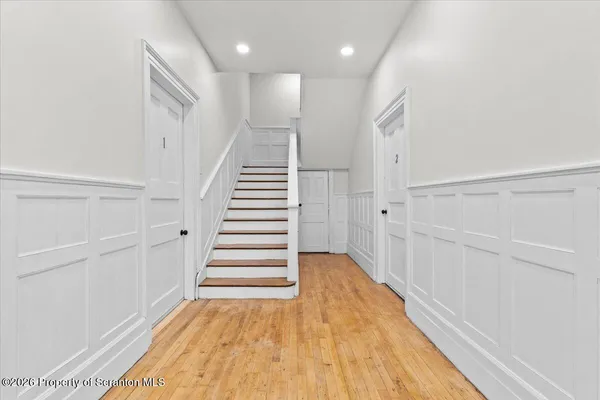 a view of entryway with wooden floor