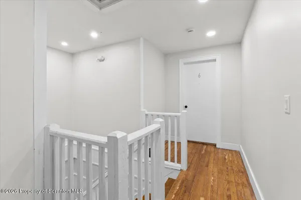 a view of hallway with wooden floor