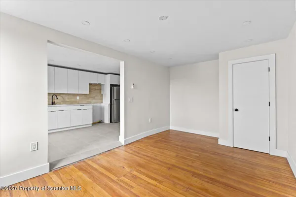 a view of a kitchen with a sink and a refrigerator