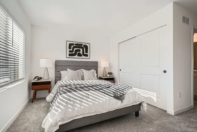 a bedroom with a bed and a table