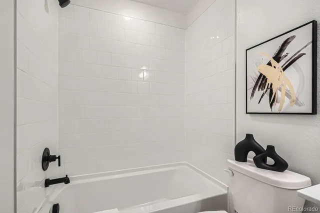 a bathroom with a toilet and a shower curtain