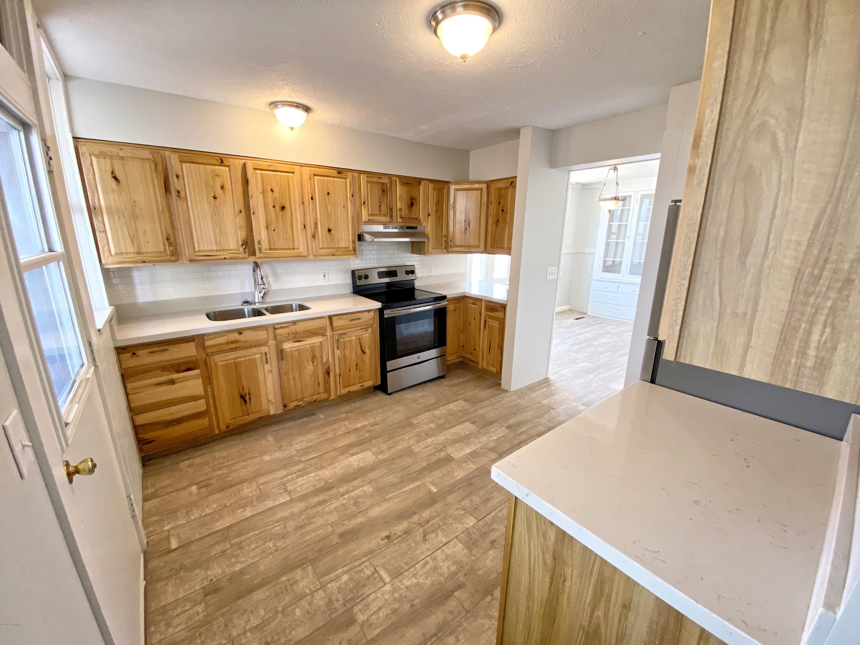 370 South 3rd Street West Snowflake, AZ 85937 - Photo 20 of 53 a large kitchen with a stove a sink dishwasher and a refrigerator