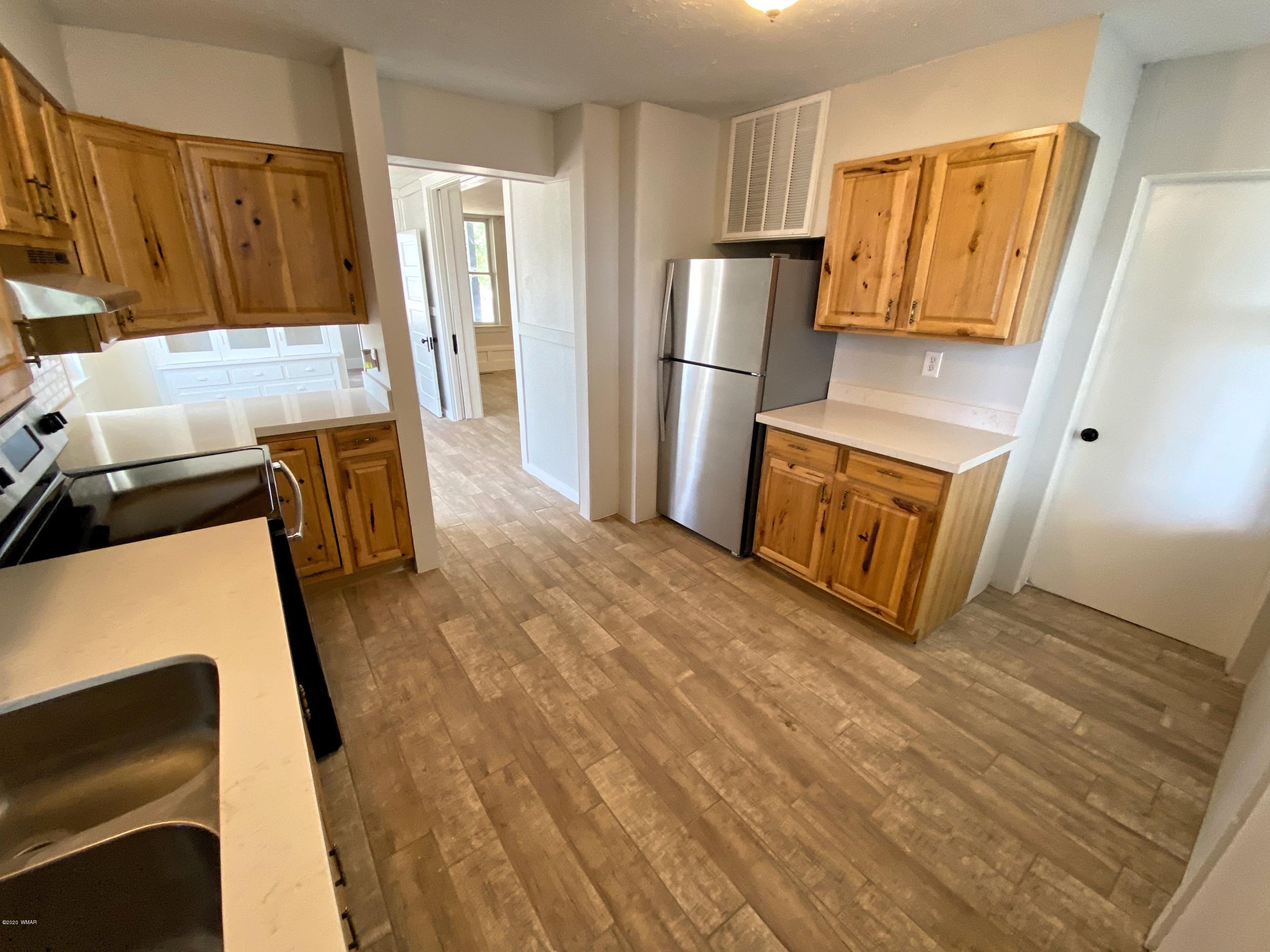370 South 3rd Street West Snowflake, AZ 85937 - Photo 21 of 53 a view of kitchen with refrigerator stove and wooden floor