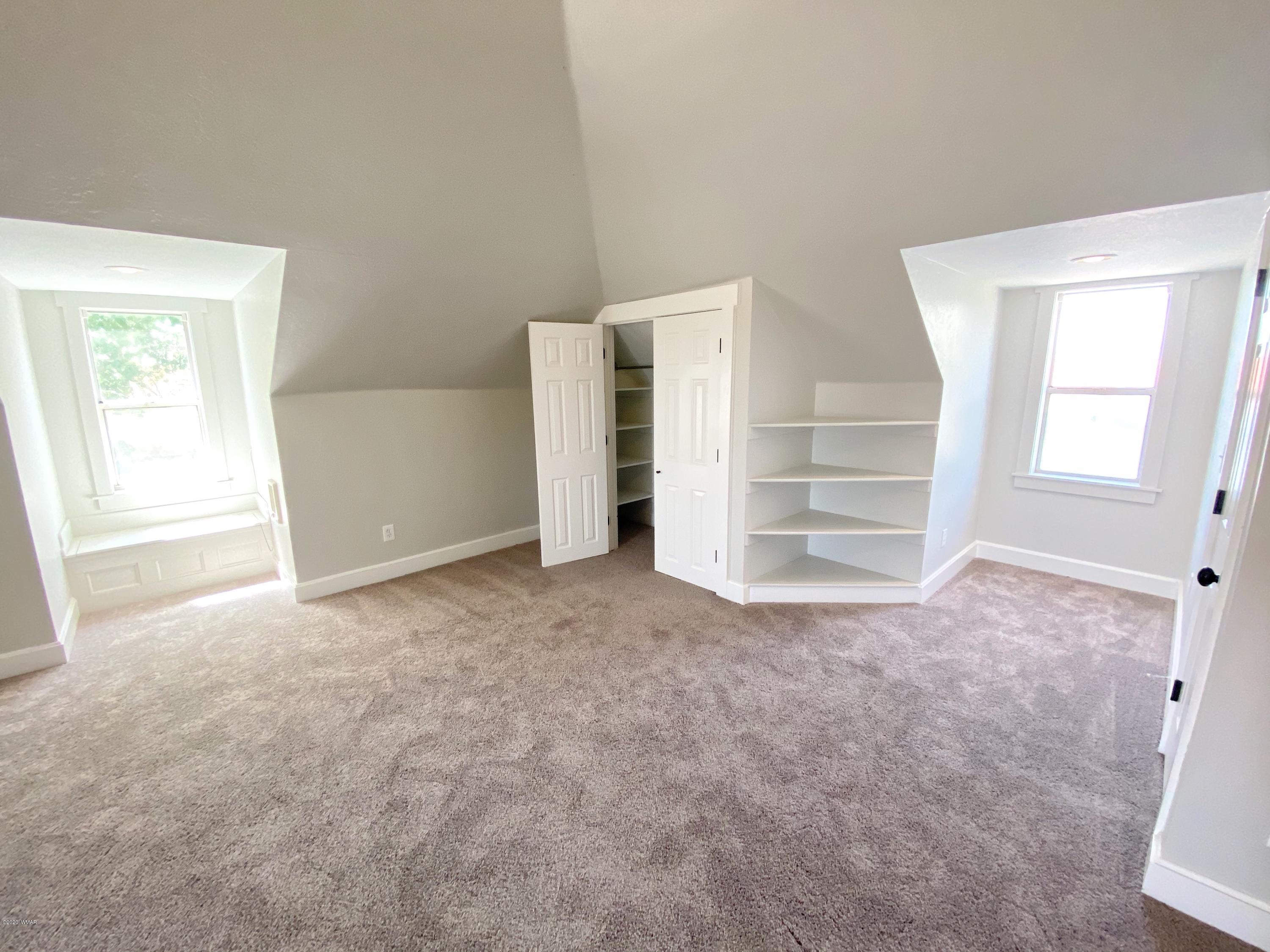 370 South 3rd Street West Snowflake, AZ 85937 - Photo 35 of 53 an empty room with a fireplace and windows
