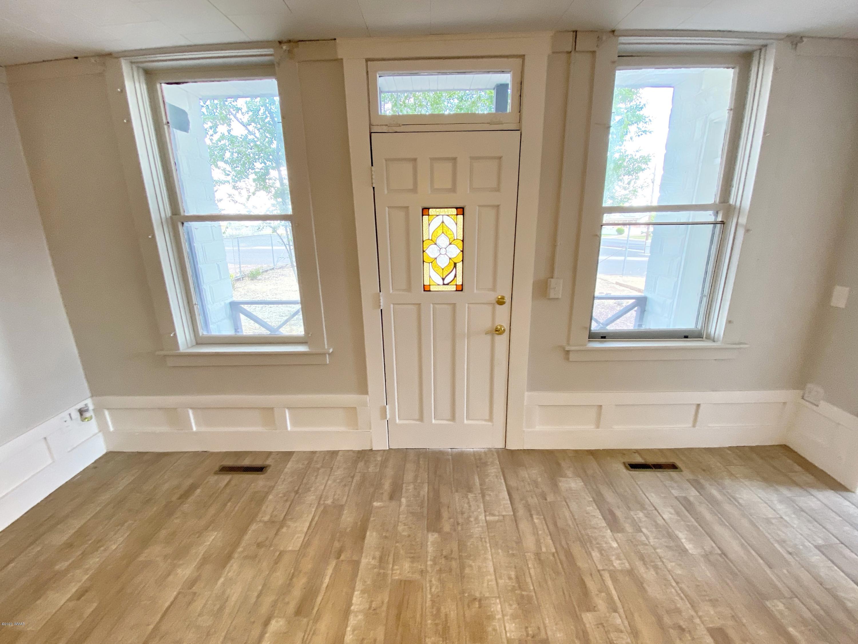 370 South 3rd Street West Snowflake, AZ 85937 - Photo 10 of 53 a view of an empty room with wooden floor and window
