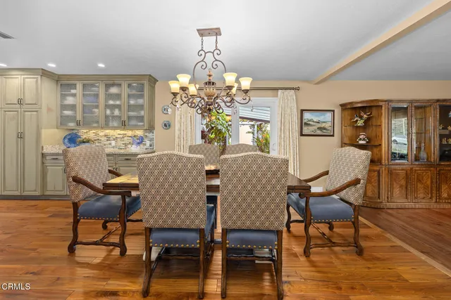 a view of a dining room with furniture wooden floor and chandelier
