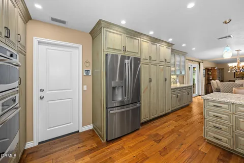 a bathroom with a stove a sink and a mirror