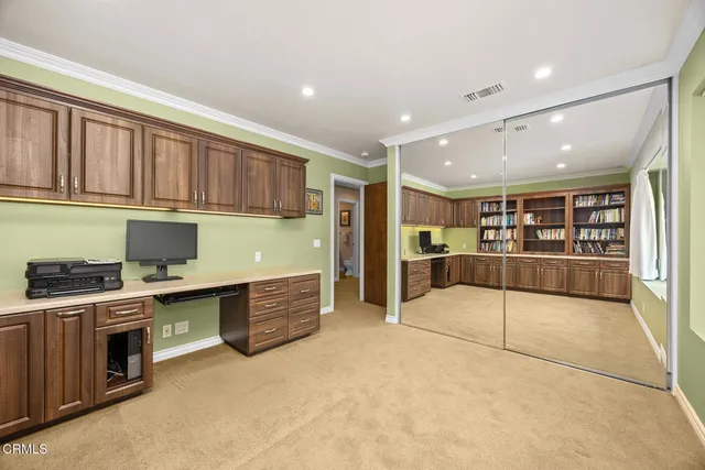 a en suite bathroom with a granite countertop sink and a mirror