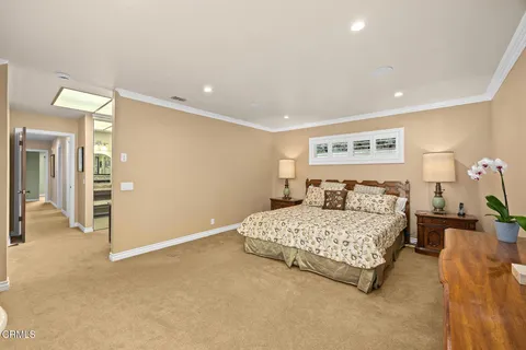 a bathroom with a granite countertop sink a mirror and shower