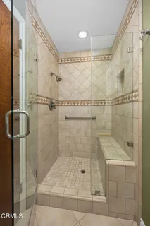 a bedroom with a bed and glass window