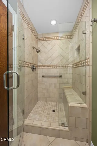 a bedroom with a bed and glass window