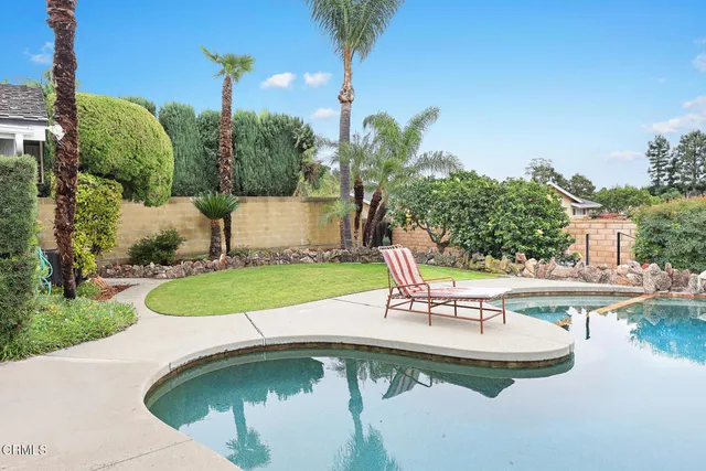 a front view of a house with a yard and flowers