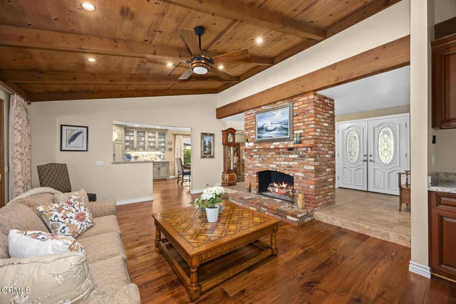 a living room with furniture a fireplace and a table