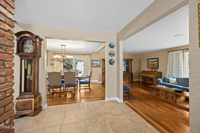 a view of a livingroom with furniture a flat screen tv and floor to ceiling window