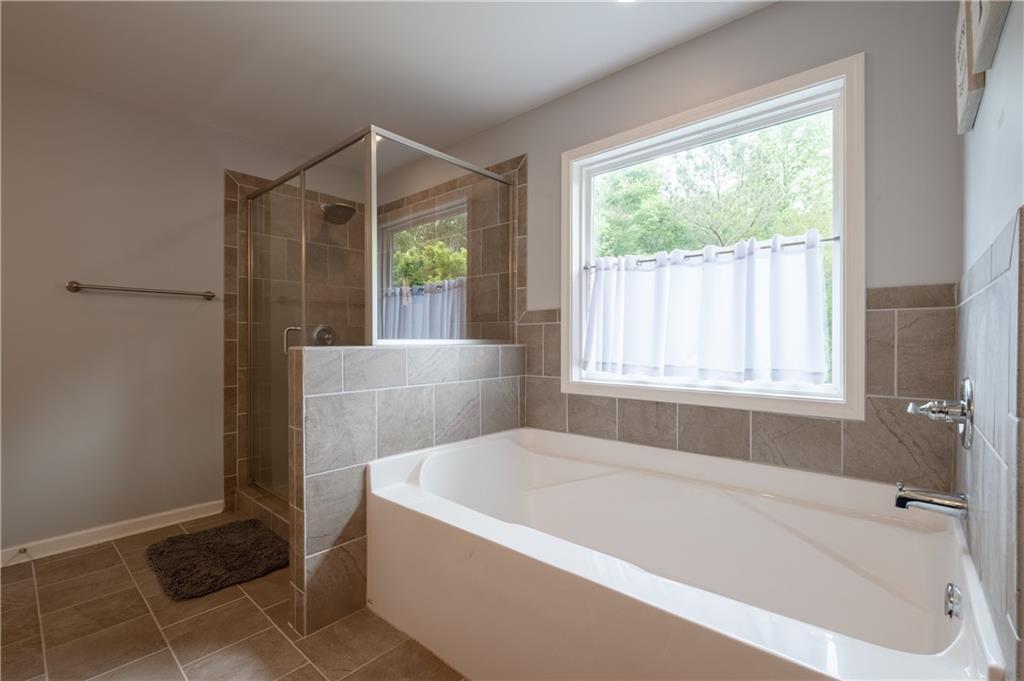 719 Fairview Road Brooks, GA 30205 - Photo 25 of 35 a white bath tub sitting in a bathroom next to a window