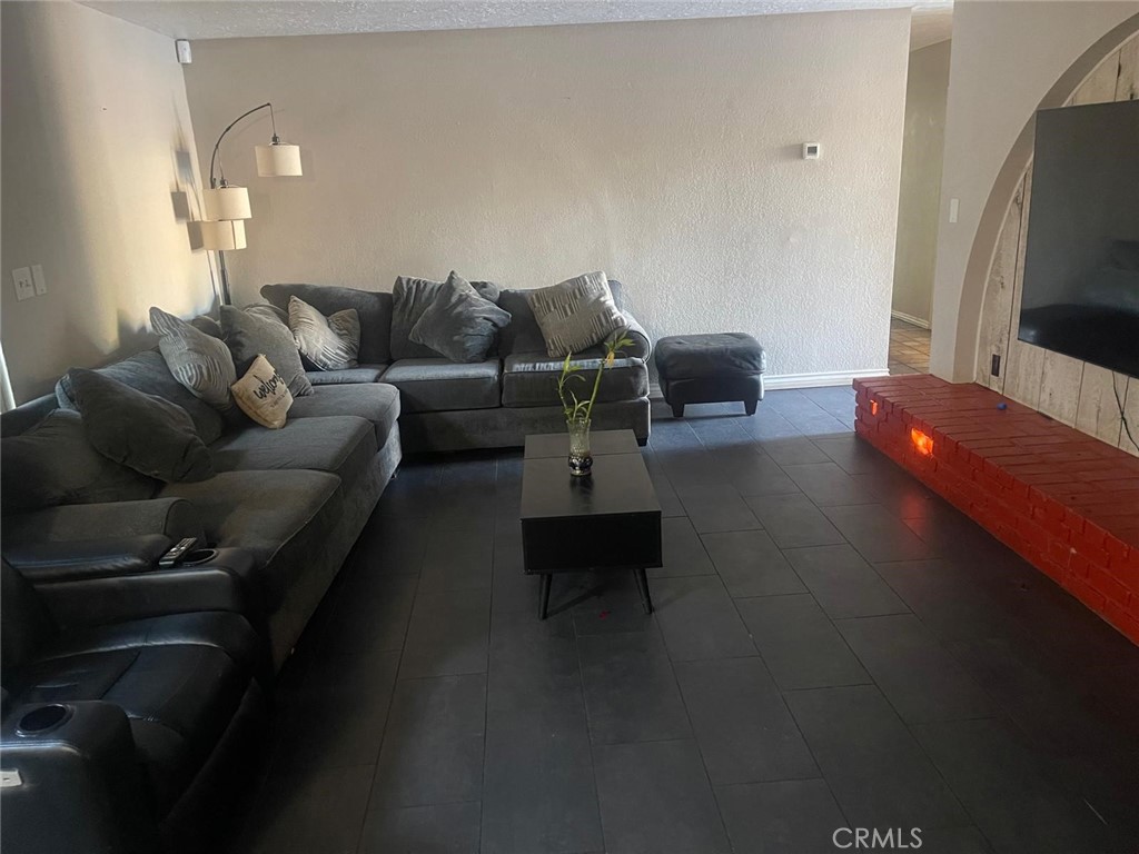 10450 Gramercy Place Riverside, CA 92505 - Photo 3 of 10 a living room with furniture and a flat screen tv