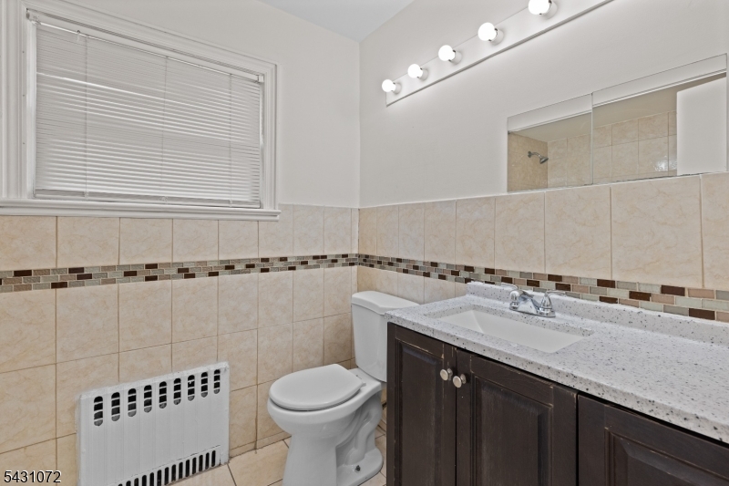 154 Ames Street Hackensack, NJ 07601 - Photo 11 of 12 a bathroom with a sink a toilet and shower
