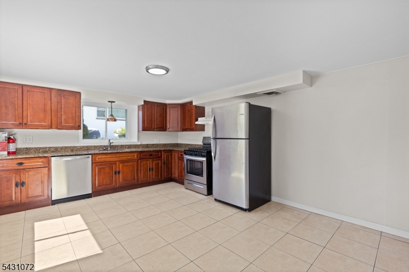 154 Ames Street Hackensack, NJ 07601 - Photo 3 of 12 a kitchen with stainless steel appliances a refrigerator and a sink