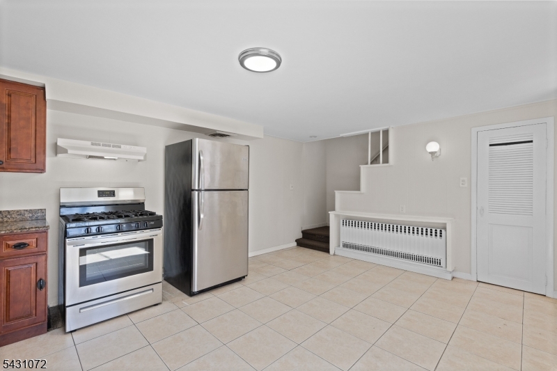 154 Ames Street Hackensack, NJ 07601 - Photo 4 of 12 a kitchen with white cabinets and refrigerator