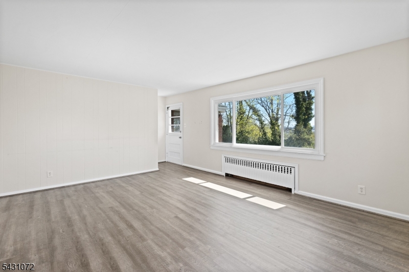 154 Ames Street Hackensack, NJ 07601 - Photo 6 of 12 an empty room with wooden floor and windows