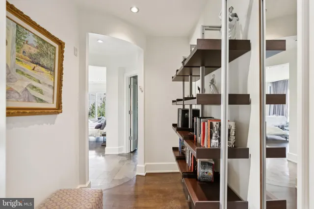 a view of hallway with stairs and furniture