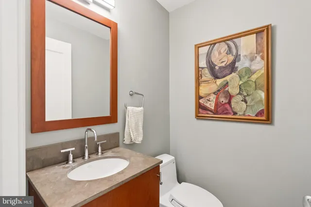 a bathroom with a toilet a sink and mirror