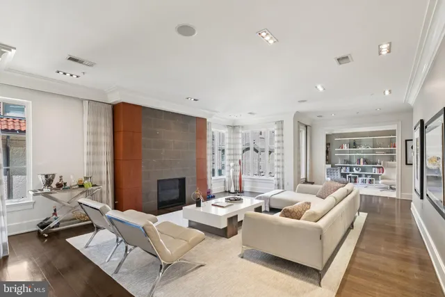 a living room with furniture fireplace and a table