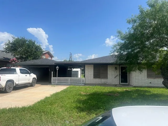 a front view of a house with a yard garage and outdoor seating