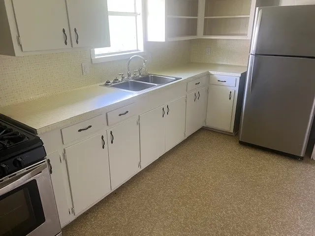 a kitchen with a sink and cabinets