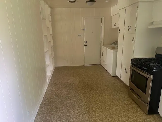 a view of a kitchen from a hallway