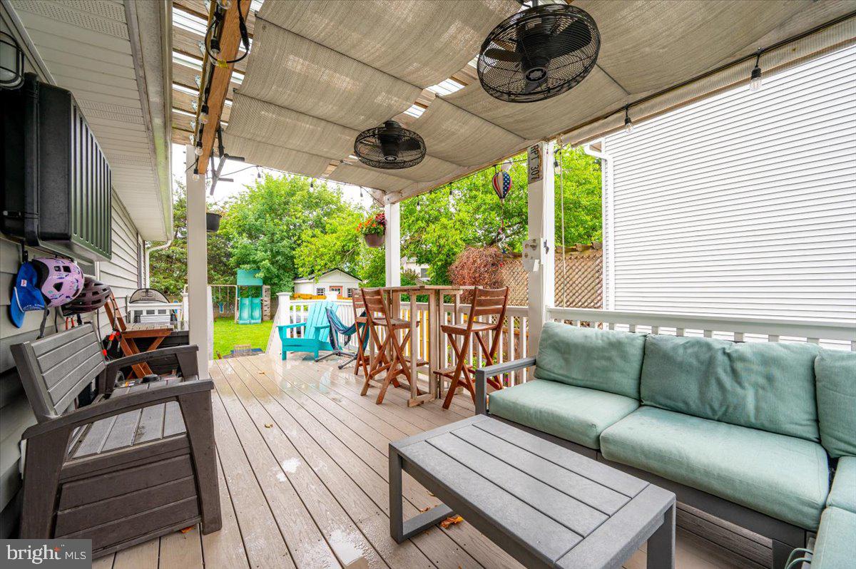 57 Spa Road Annapolis, MD 21401 - Photo 31 of 39 a view of a patio with couches chairs potted plants and a dining table with chairs