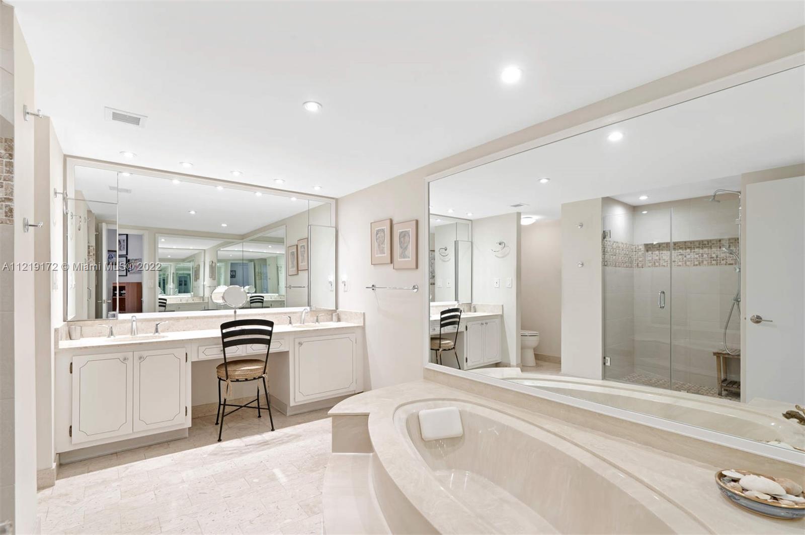 1121 Crandon Boulevard, Unit E801 Key Biscayne, FL 33149 - Photo 14 of 29 a large white bathroom with a tub sink and mirror