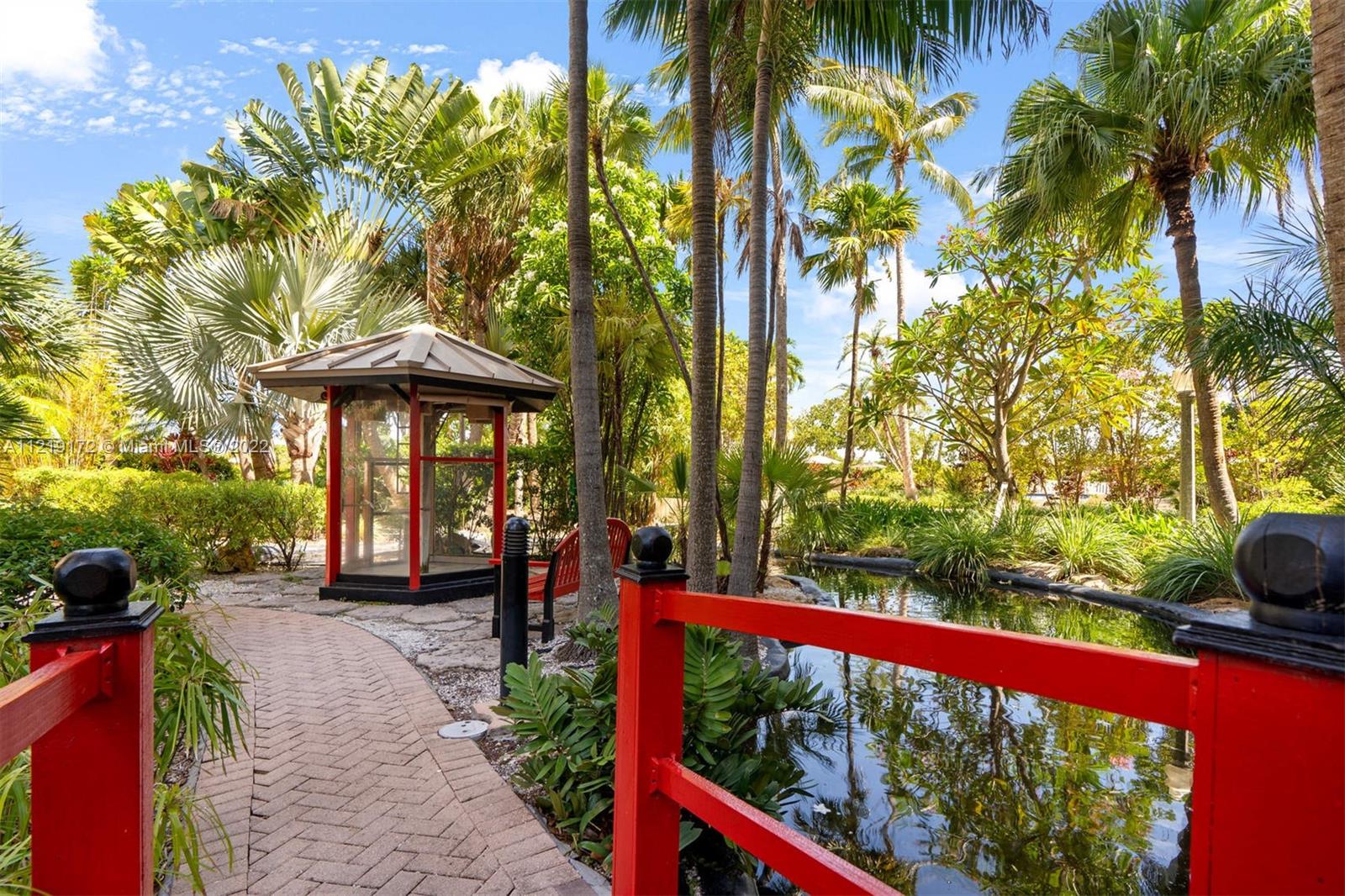 1121 Crandon Boulevard, Unit E801 Key Biscayne, FL 33149 - Photo 23 of 29 a view of a porch with a bench in a patio