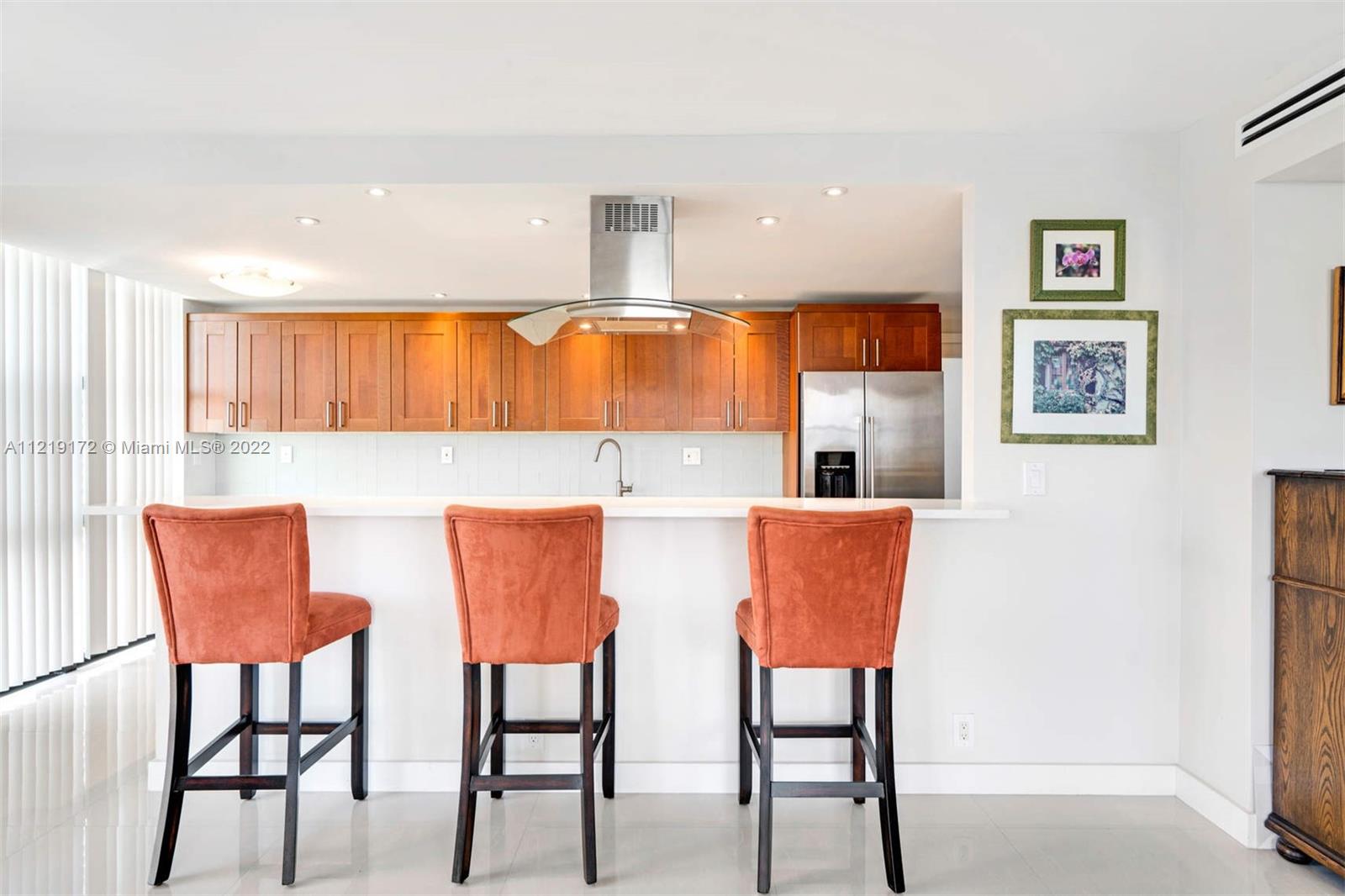 1121 Crandon Boulevard, Unit E801 Key Biscayne, FL 33149 - Photo 9 of 29 a view of kitchen and dining area with stainless steel appliances