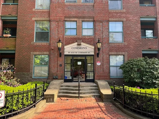a view of a brick building with many windows